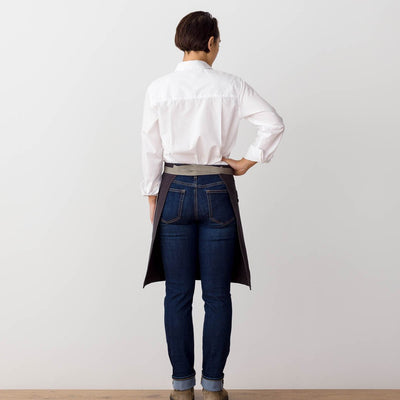 Bistro Apron on Model, Rear View, Charcoal Black with Tan Straps, Server, Reluctant Trading