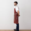 Chef's Apron, Maroon with Tan Straps, Men or Women, Model side view-The Reluctant Trading Experiment